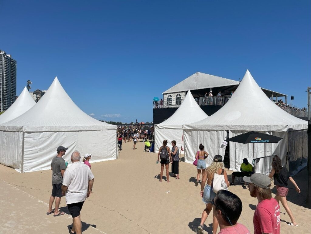 Multiple High Peak tents with curtained walls